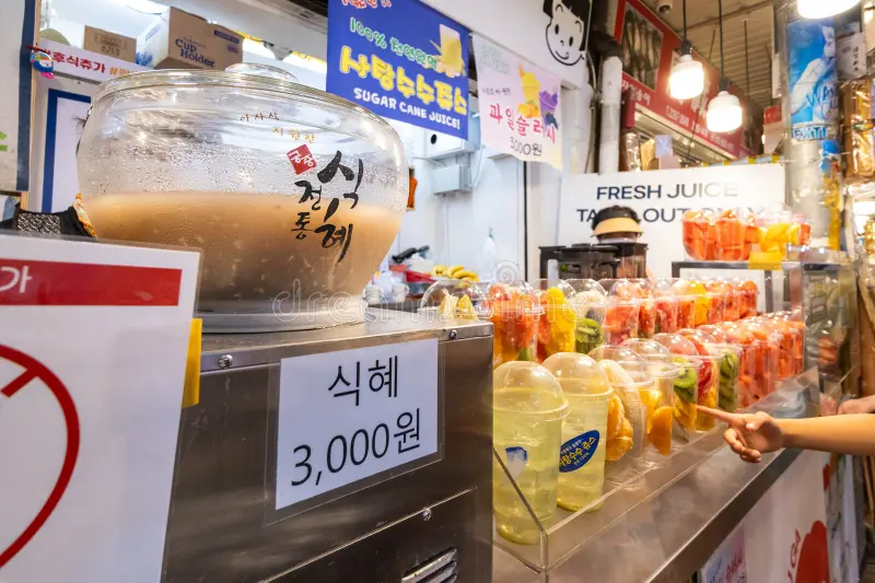 stall-sells-sikhye-sweet-rice-drink-freshly-cut-fruits-disposable-cups-famous-korea-traditional-food-market-kwan-jang-417126791